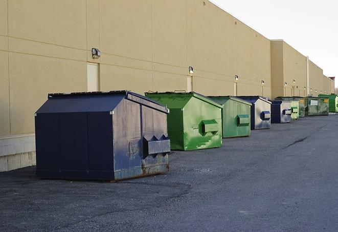 a group of construction workers taking a break near a dumpster in Locust Hill VA